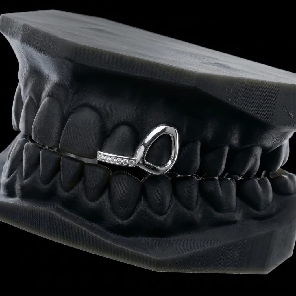 Window cap on the canine with a stone-set bar across the lateral incisor, in silver